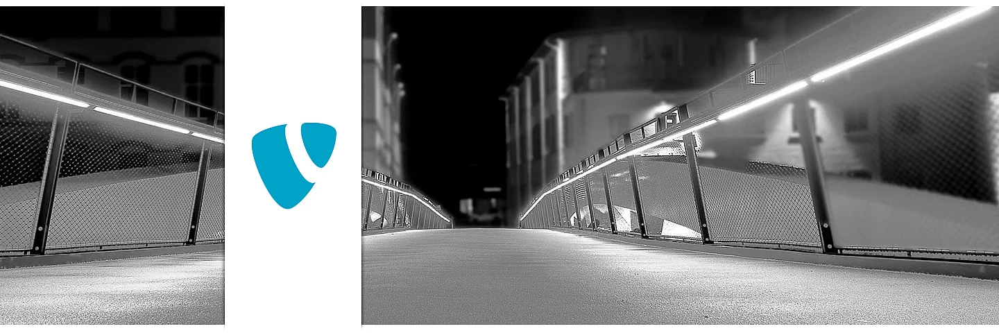 Ihre TYPO3 Agentur für Lüdenscheid – Webdesign & CMS aus einer Hand Nachtaufnahme einer Fußgängerbrücke in Lüdenscheid – Symbol für moderne TYPO3 Websites